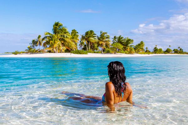 A cruise ship brochure with discounted prices and deals highlighted, placed next to a laptop and travel planner
