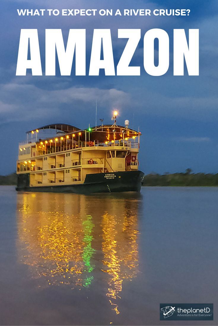 Cruise ship navigating the Amazon River surrounded by lush rainforest.